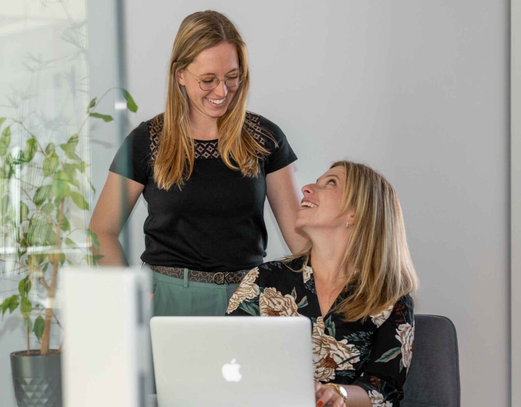Alex und Tina von Wunschfinanzierung besprechen gemeinsam eine Baufinanzierung und beraten Kunden persönlich zur Immobilienfinanzierung.